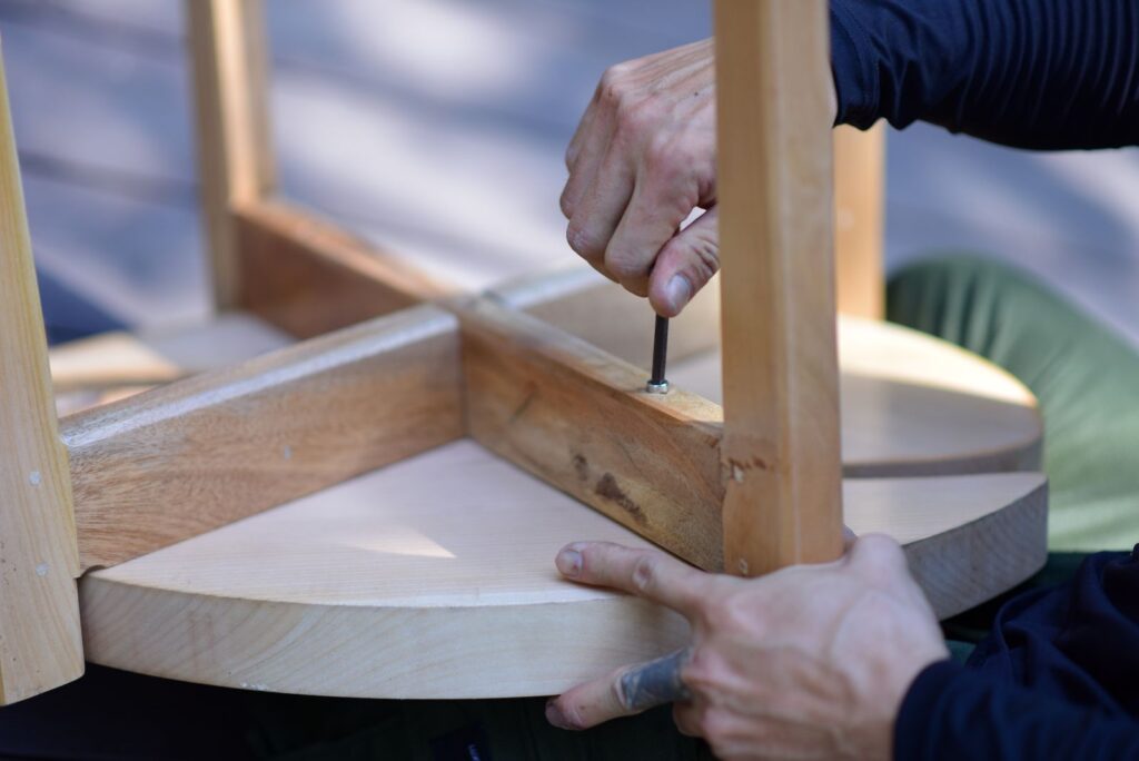 Hands assembling wooden furniture