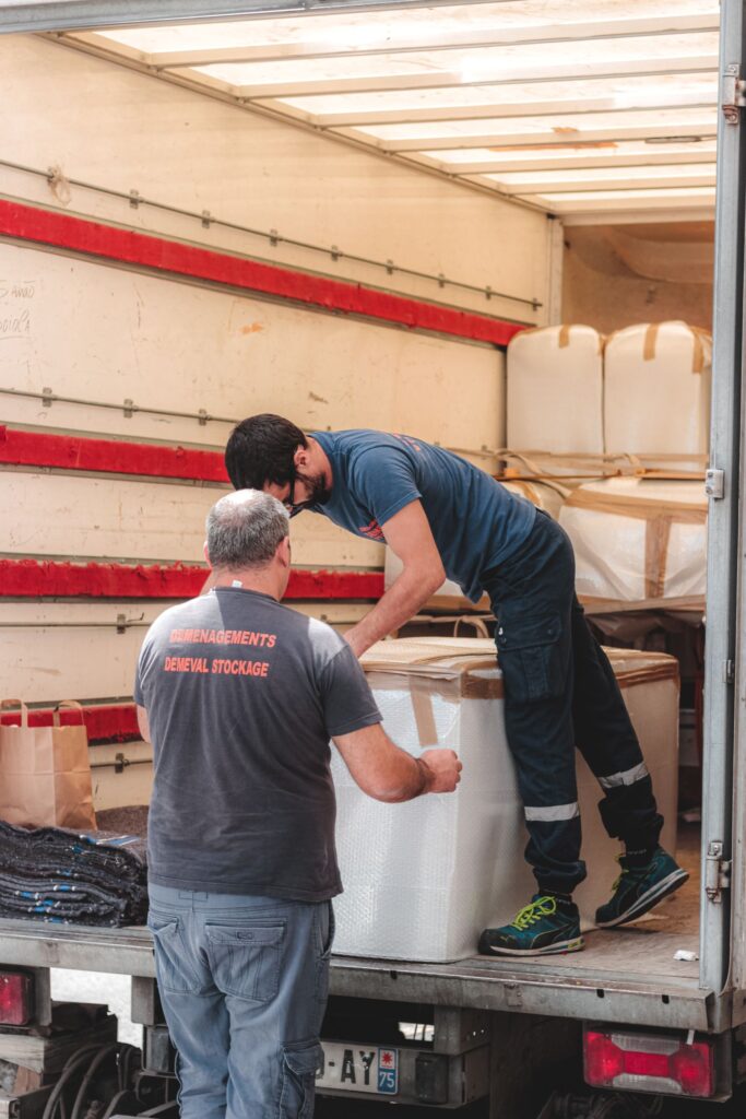 Movers organizing boxes inside a truck