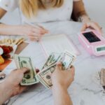 Budgeting a move with cash, calculator and notebook