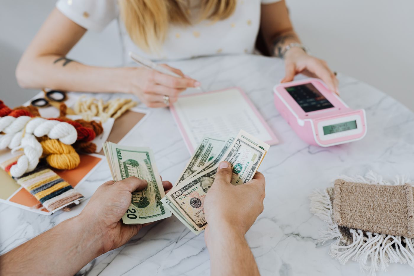 Budgeting a move with cash, calculator and notebook
