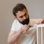 Assembling a crib with a screwdriver during a move